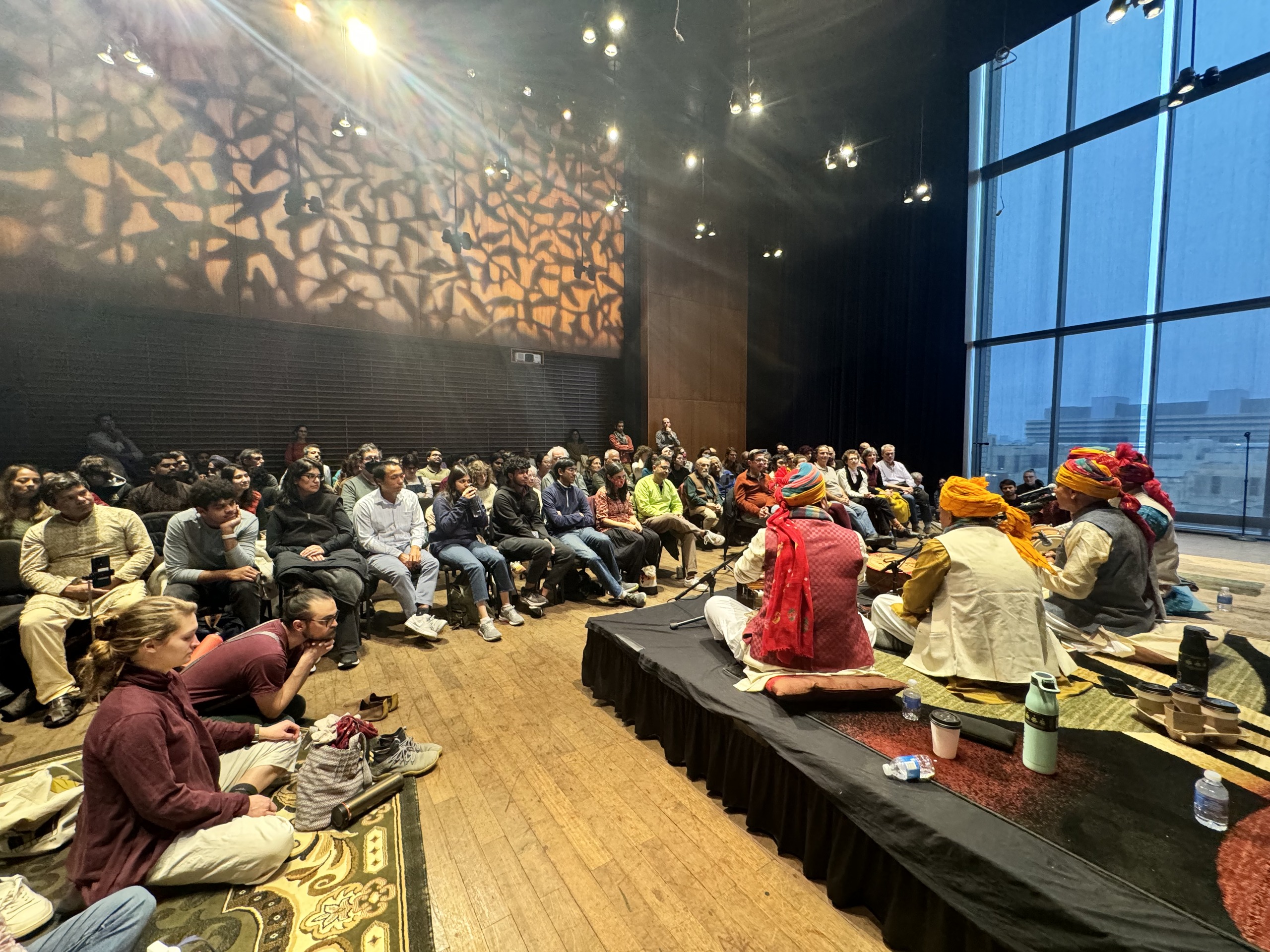 Prahlad Singh Tipaniya Ji and ensemble performing for a large audience