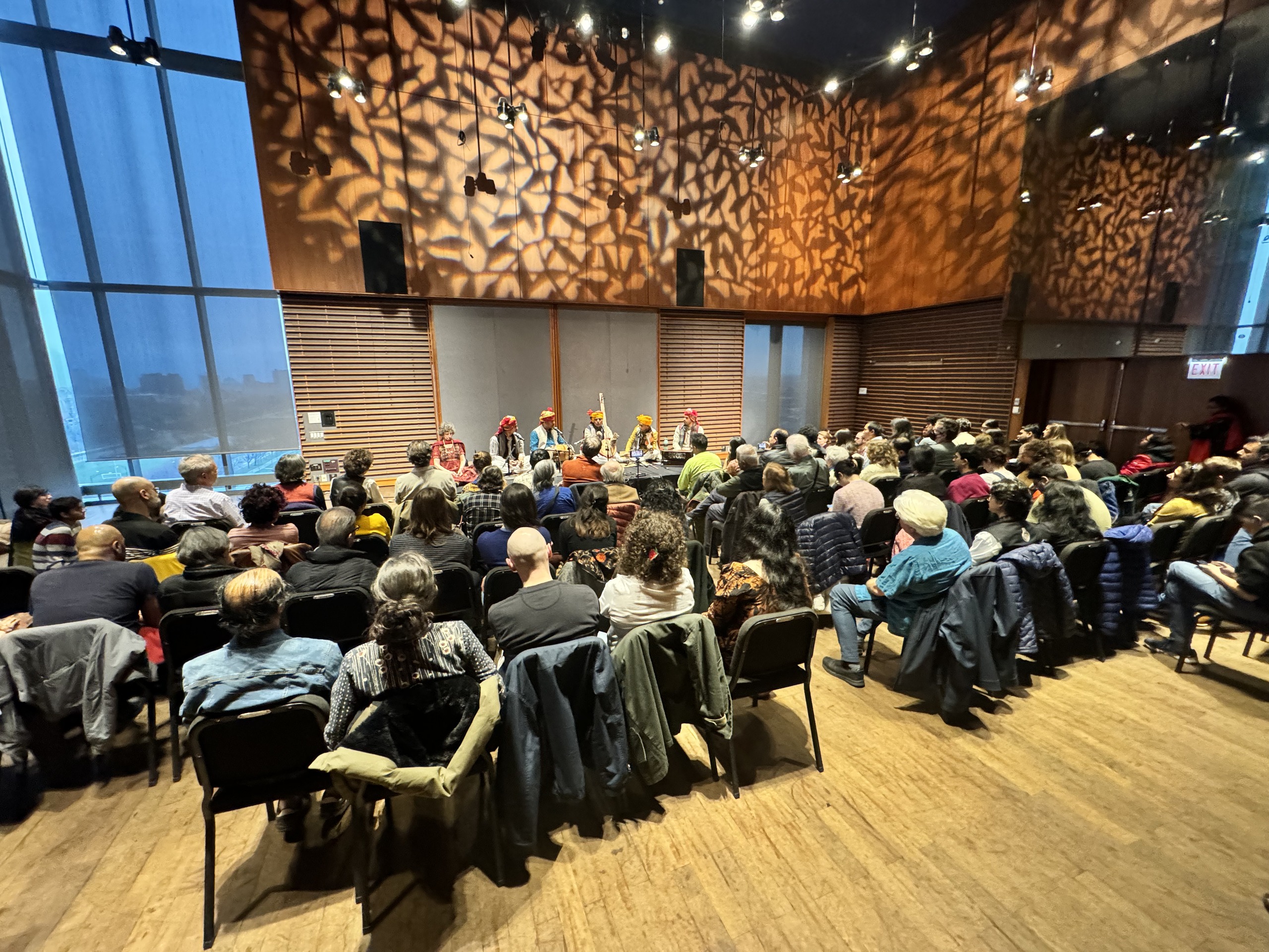 A full audience listening to a contemplative song performance